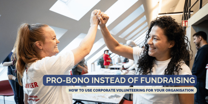 Two women give each other a high-five at a social day team event