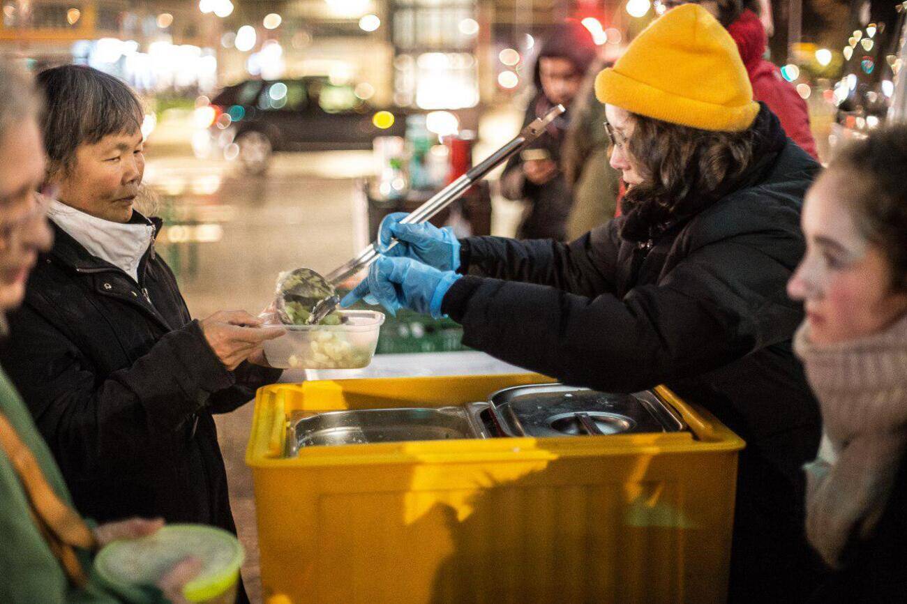 Providing homeless people on the street with food and clothing donations